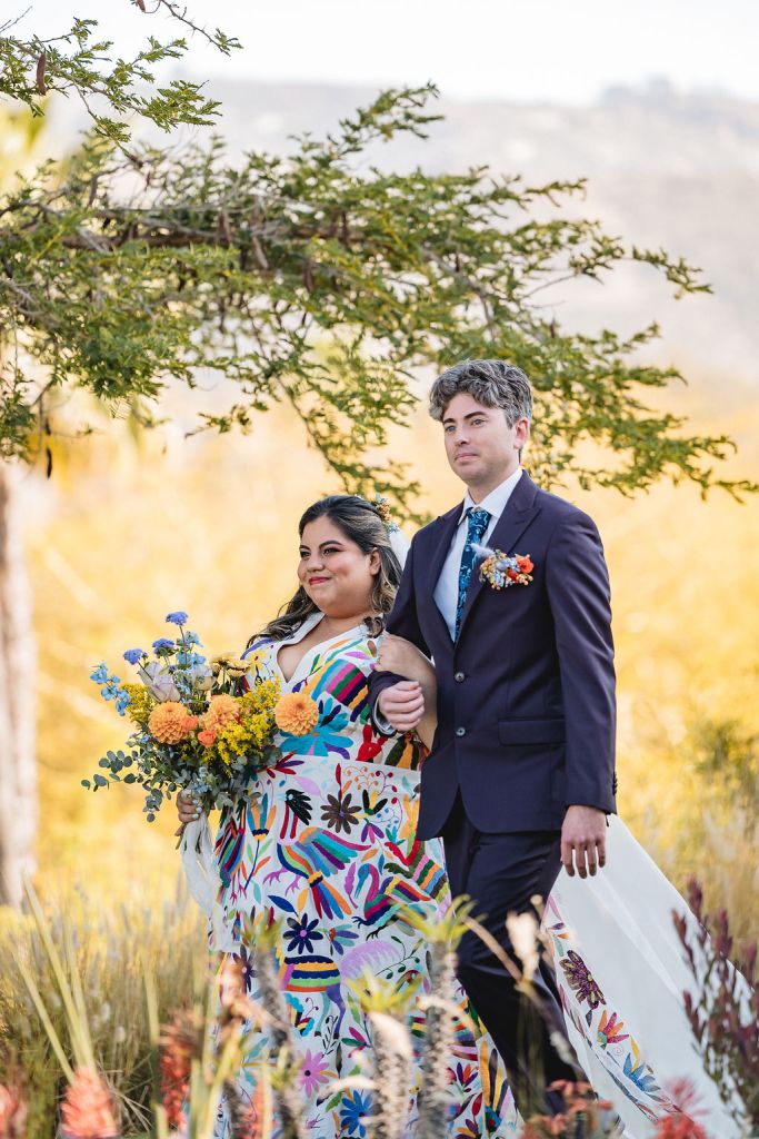 Jennifer and Matthew walking into their wedding ceremony outside